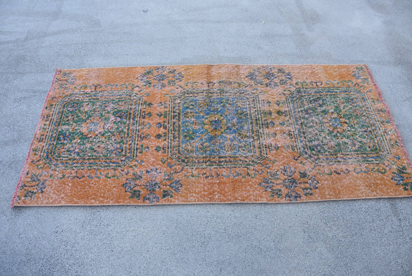 Vintage Orange Wool Rug: Geometric & Floral Design